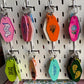 Colorful keychains hanging on a pegboard