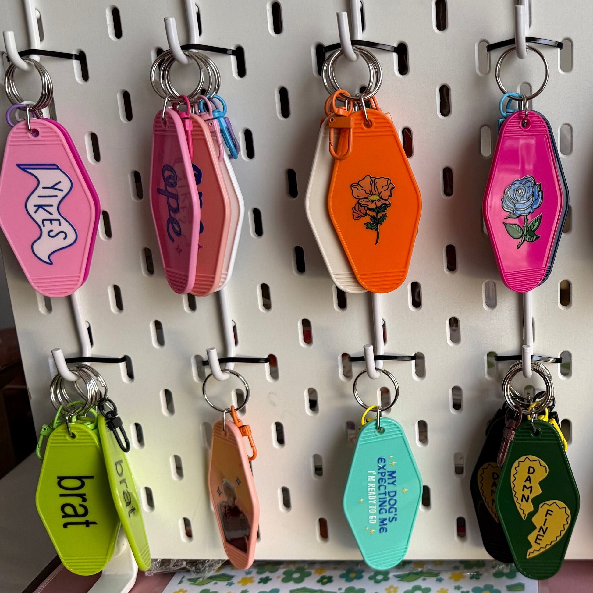 Colorful keychains hanging on a pegboard