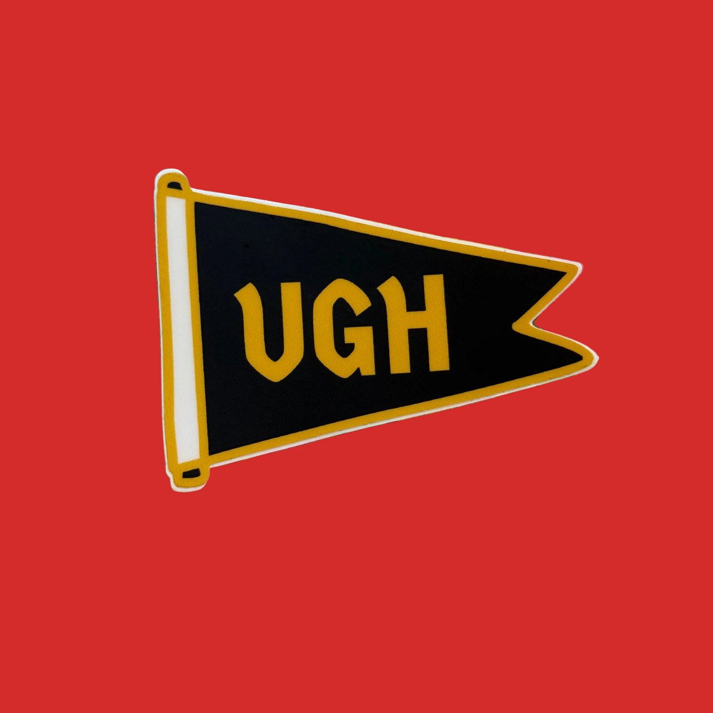 A black pennant-shaped sticker with yellow lettering that reads 'UGH' and a yellow border, shown on a solid red background.